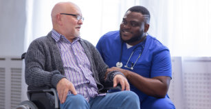 Caregiver and old man in a wheelchair