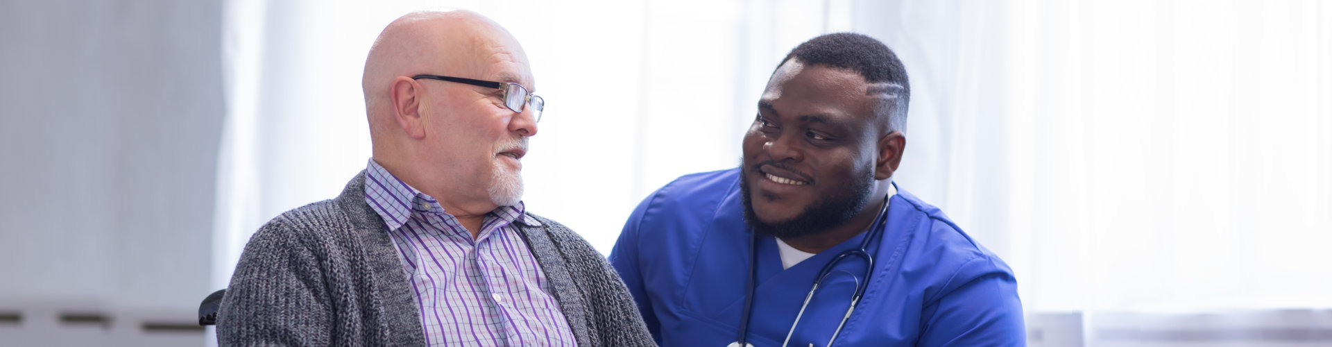 Caregiver and old man in a wheelchair