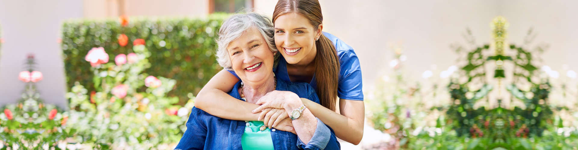 Shot of a resident and a nurse outside in the retirement home garden.