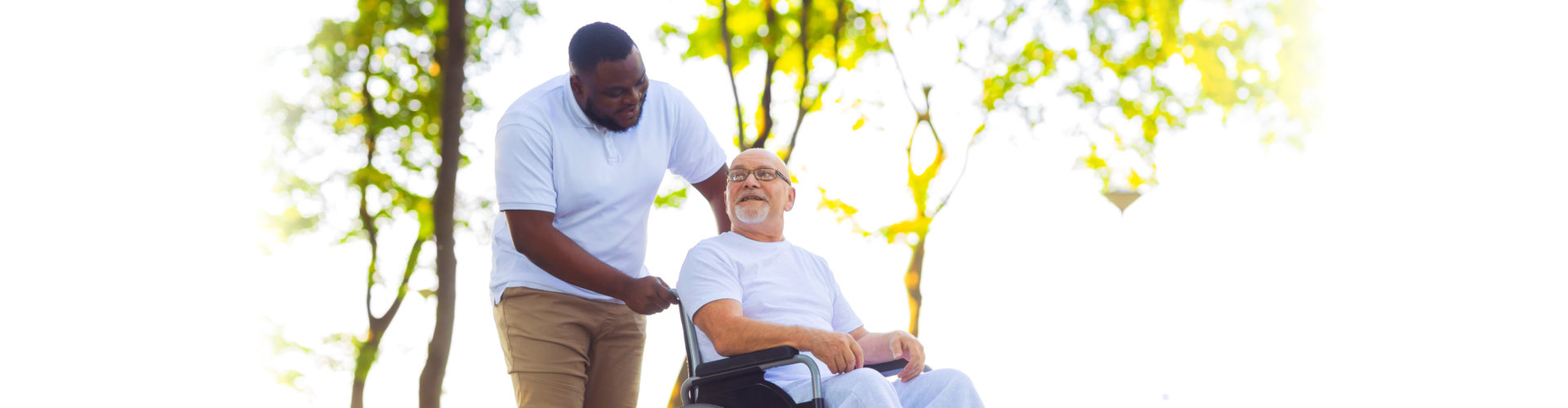 Caregiver and old man in a wheelchair.